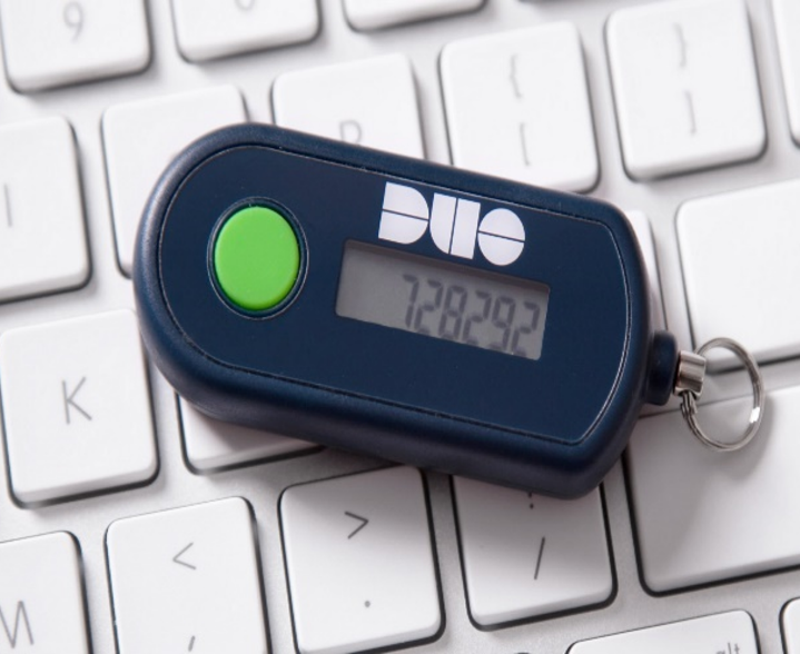 A hardware one-time-password token resting on a computer keyboard